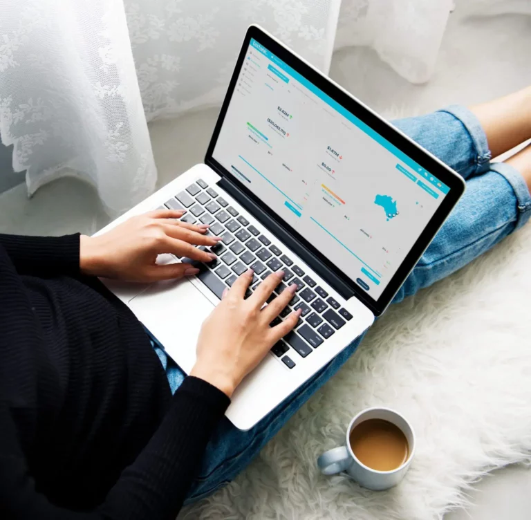 Woman sitting on ground using property accounting software, TaxTank