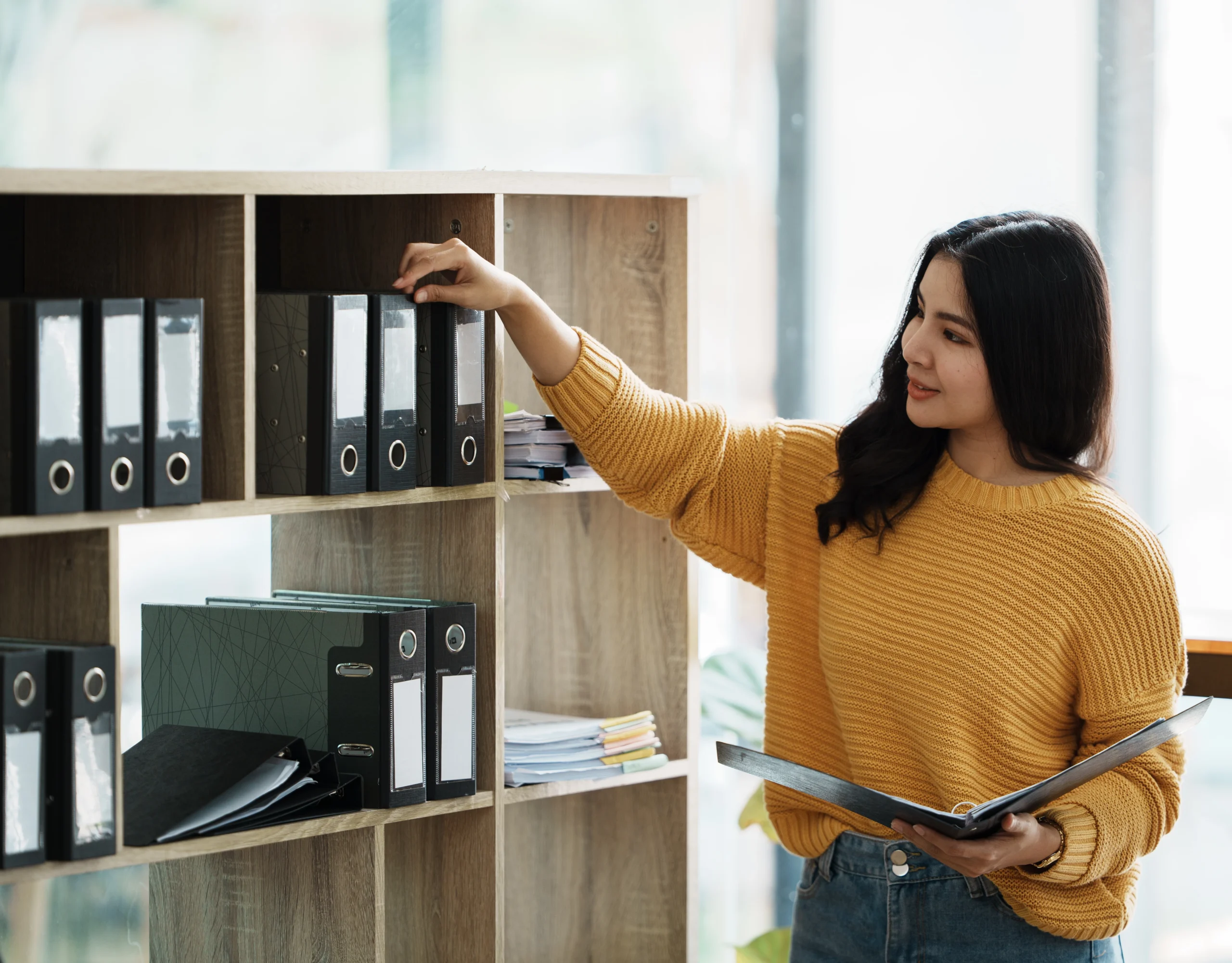 Young woman setting up a filing system.