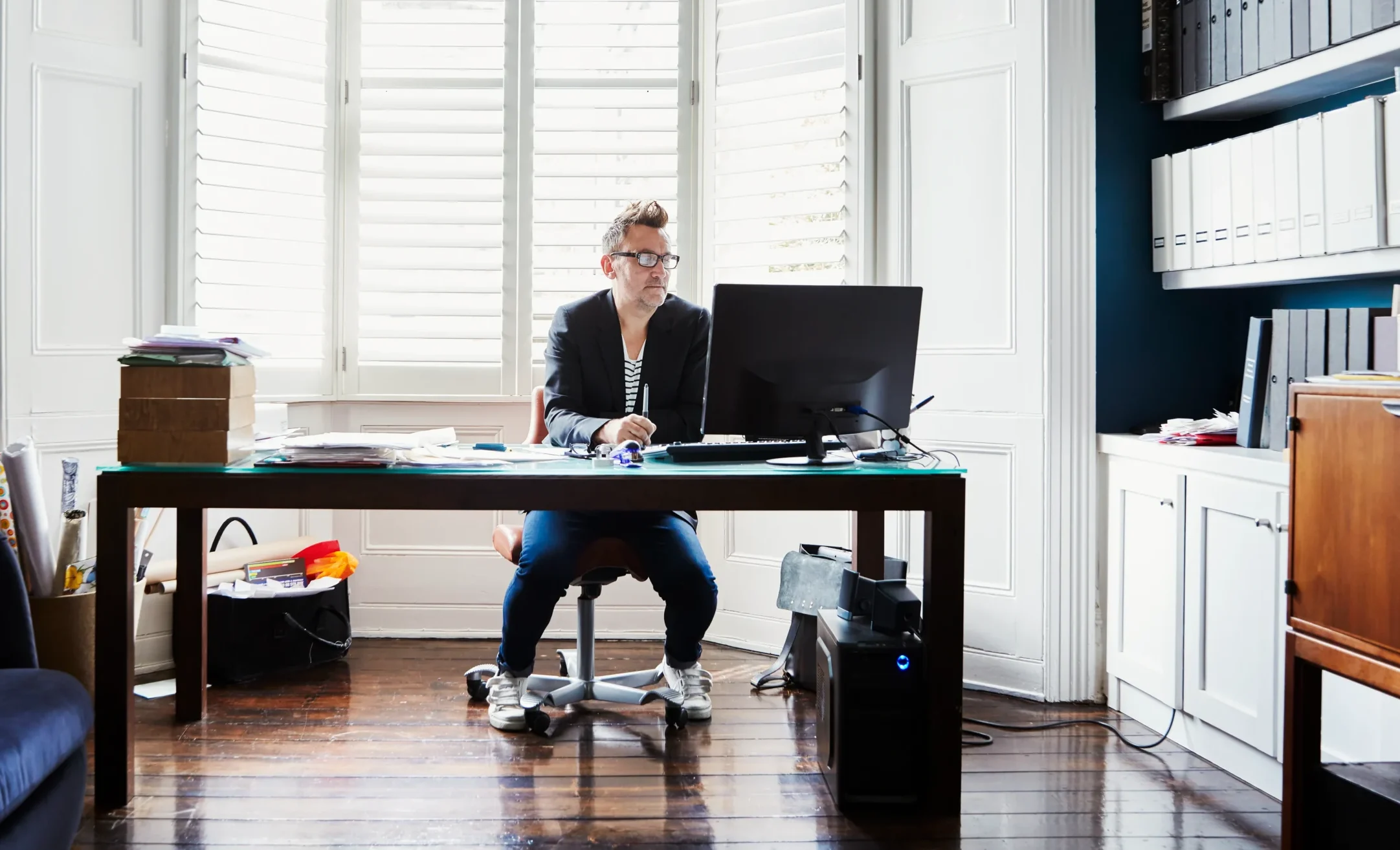 A man sitting at his desk working how his Working From Home Tax Deductions