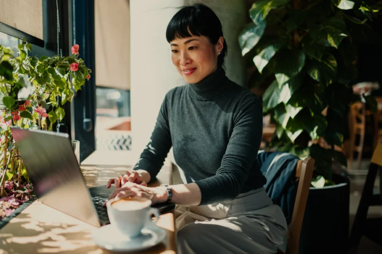 asian woman on laptop searching for tax apps