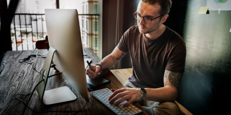 Young man working on his business bank account as a sole trader