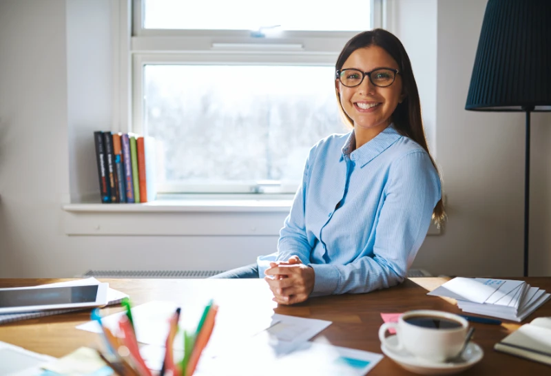 Junior accountant smiling getting ready to do all the menial tax return work.