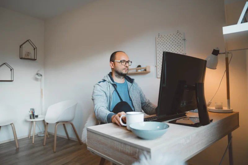 Man on computer calculating work from home deductions