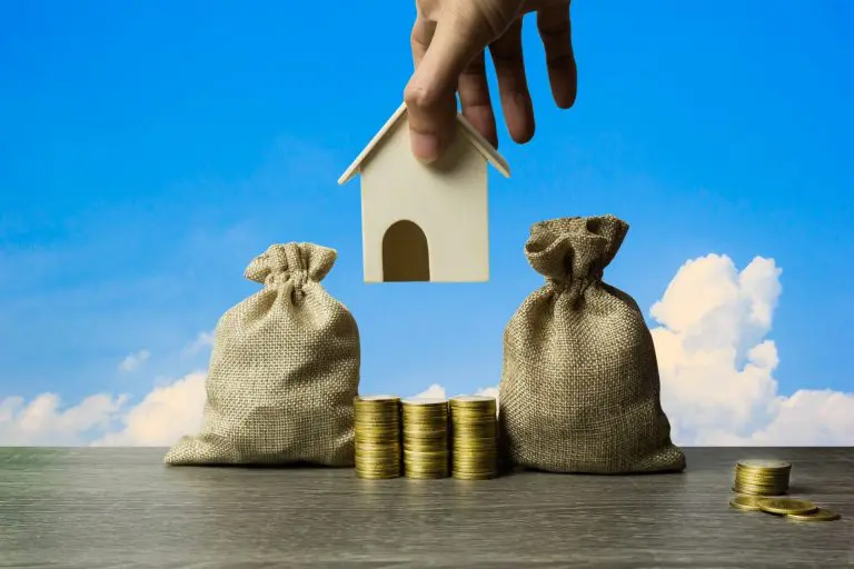 Image with money, coins and house to illustrate negative gearing
