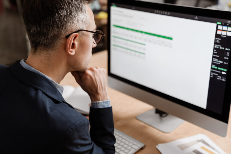 Property investor looking at spreadsheet with no real-time tax visibility