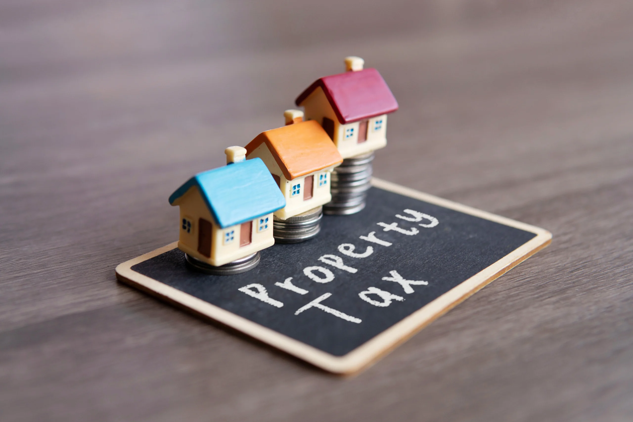 toy house and chalkboard with text property tax