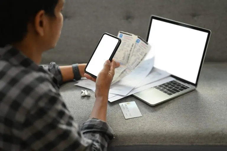 Young man using tax software to upload his receipts.